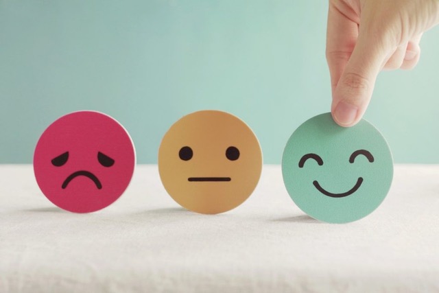 three round imogi faces, one sad, one neutral and one smiling.